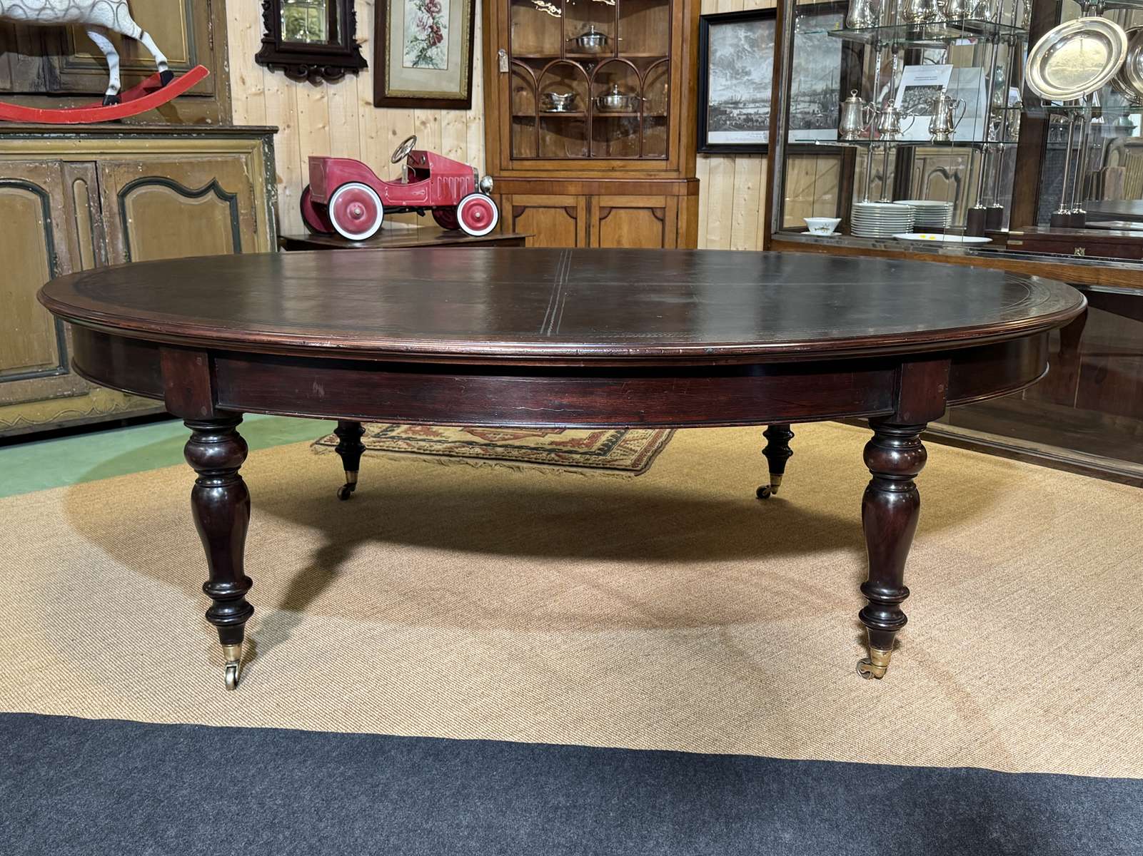 Large English library table in dark walnut with a leather top.