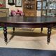 Large English library table in dark walnut with a leather top.