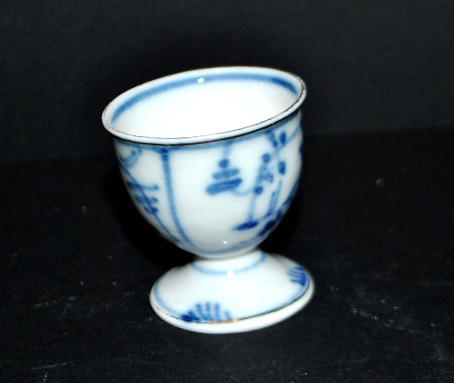 Antique porcelain diabolo egg cup with blue hand-painted onion decoration