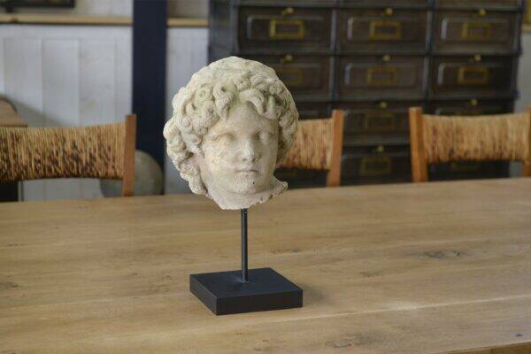 Sculpture of a head in reconstituted stone carved in the antique style of the 19th century