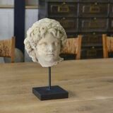 Sculpture of a head in reconstituted stone carved in the antique style of the 19th century