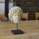 Sculpture of a head in reconstituted stone carved in the antique style of the 19th century