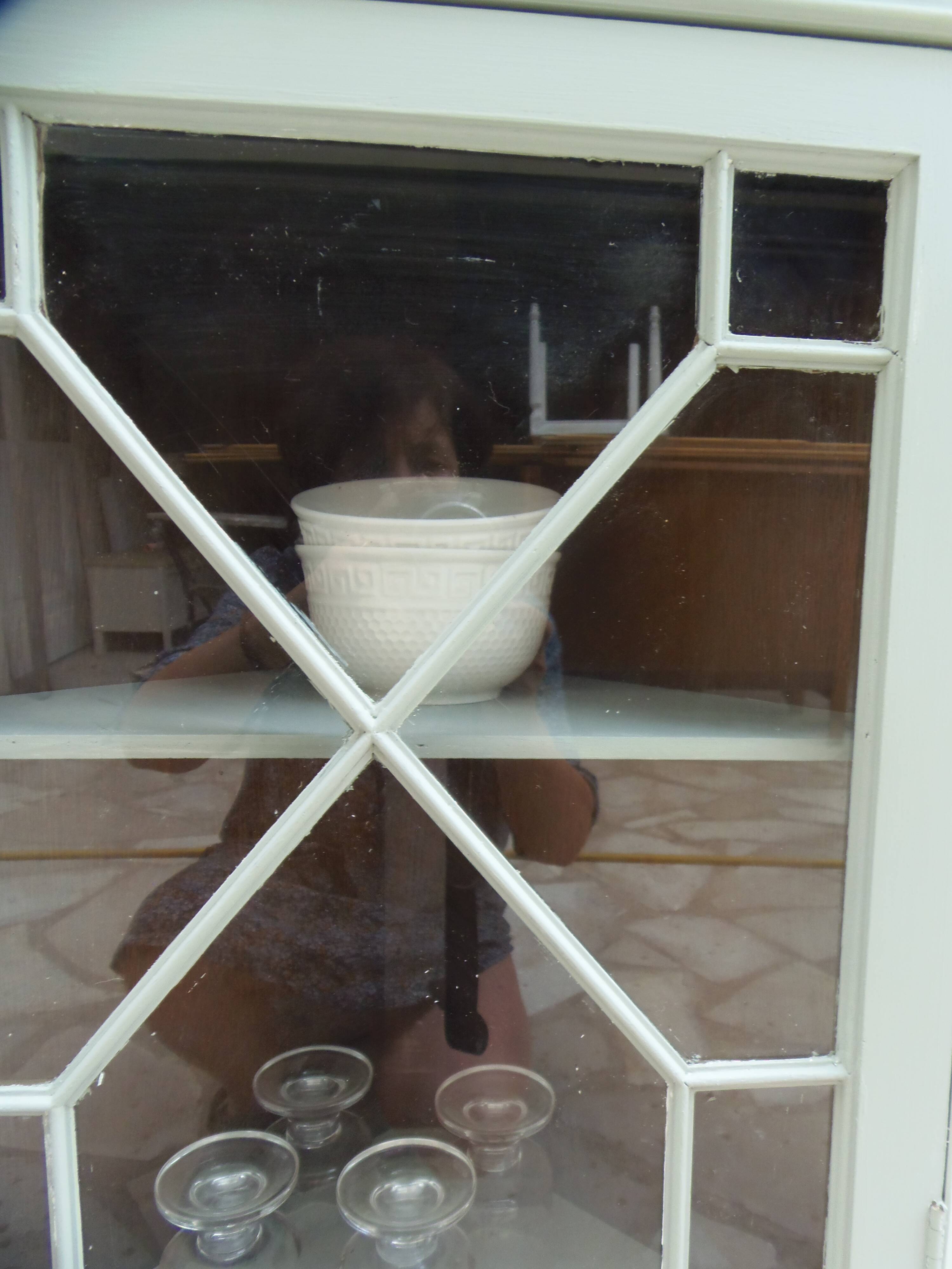 Vintage English corner display cabinet enhanced in grey-green with a wooden top.