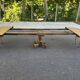 Round dining table with a central pedestal, stripped raw oak, 4 extensions, 19th century.