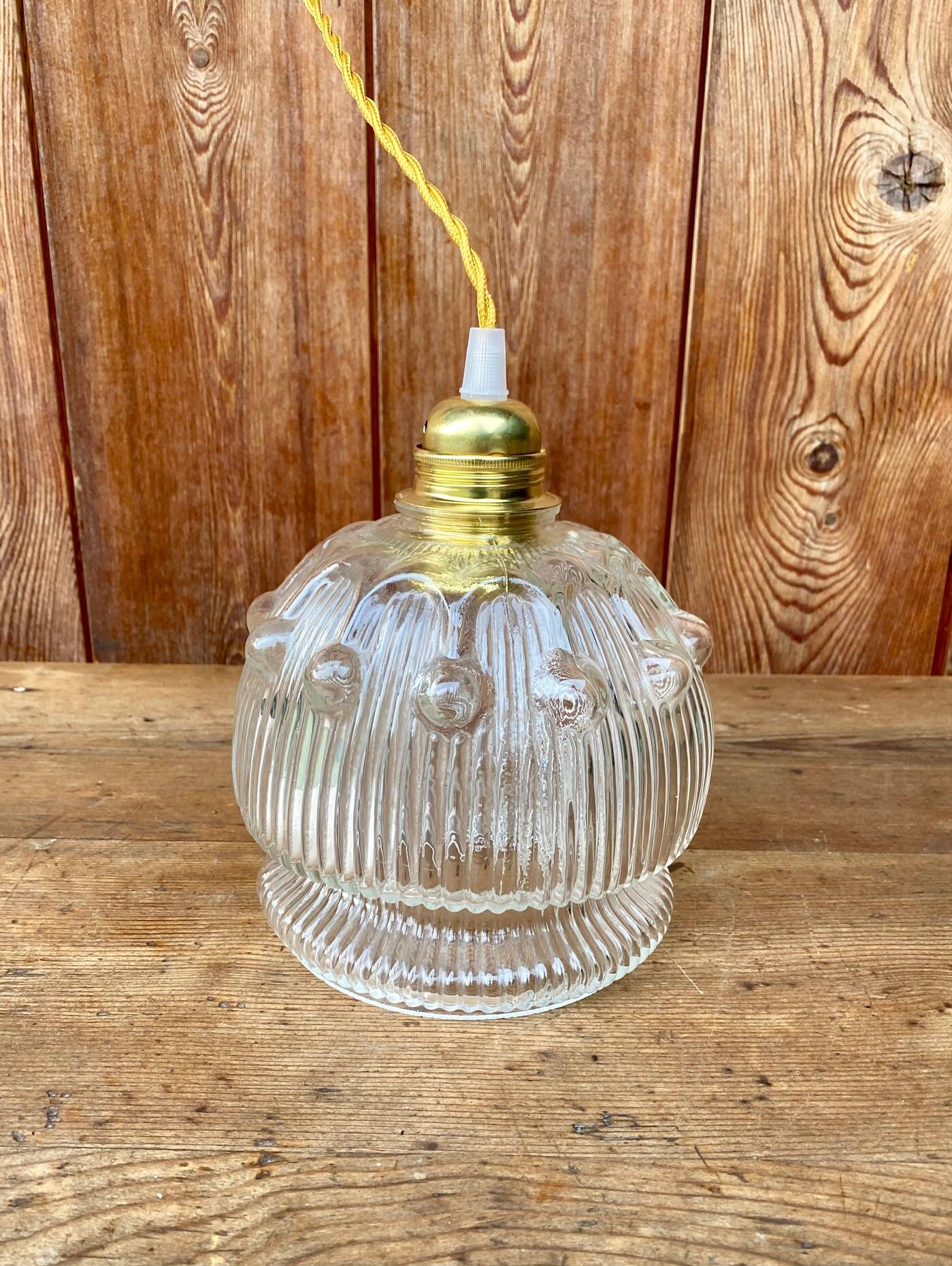 Vintage flower-shaped transparent glass pendant globe.