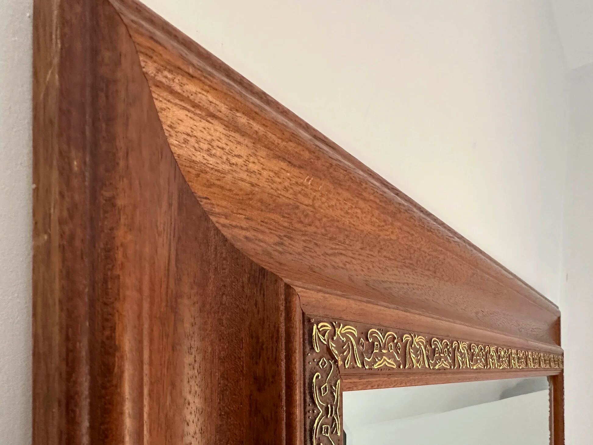 Large bevelled tabletop mirror in carved gilded wood.