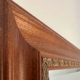 Large bevelled tabletop mirror in carved gilded wood.