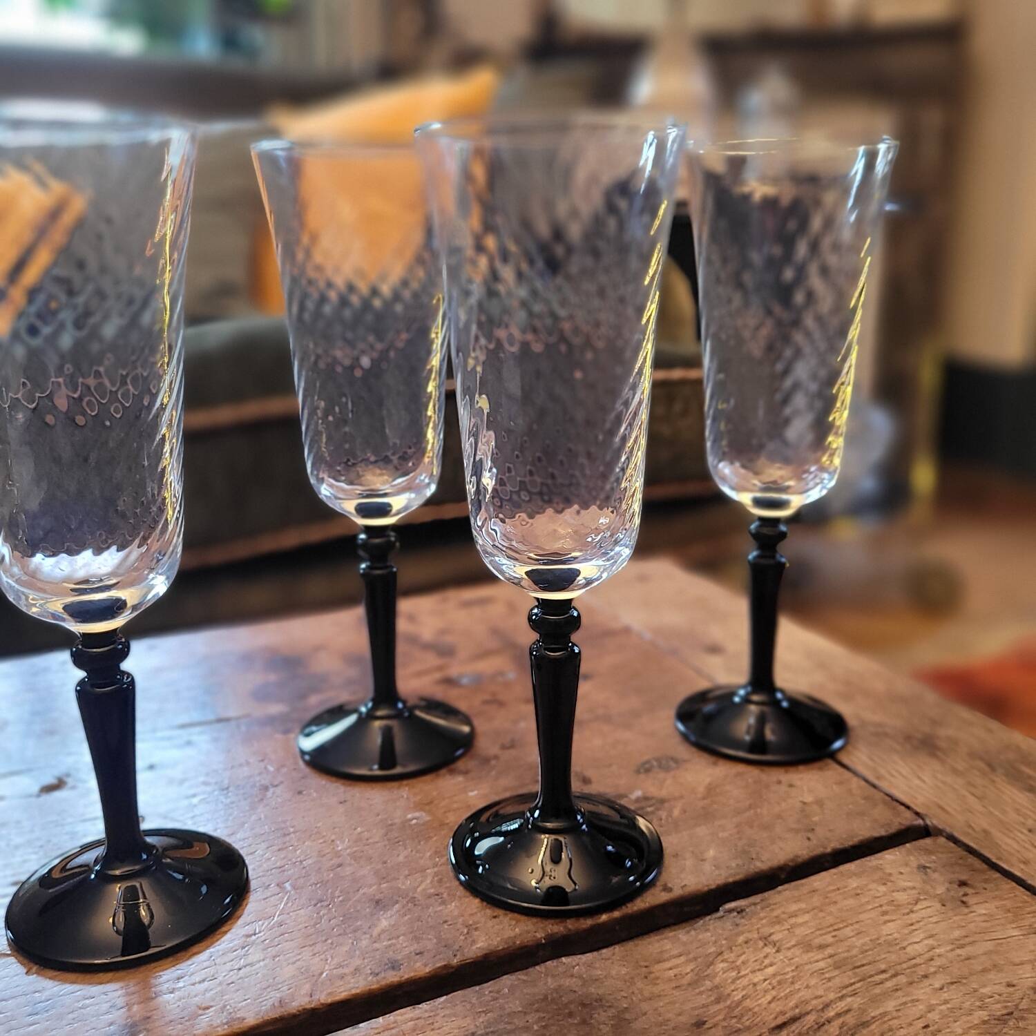 4 clear glass flutes with black stems. 1960–1970. 4 clear glass flutes with black stems.