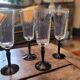 4 clear glass flutes with black stems. 1960–1970. 4 clear glass flutes with black stems.