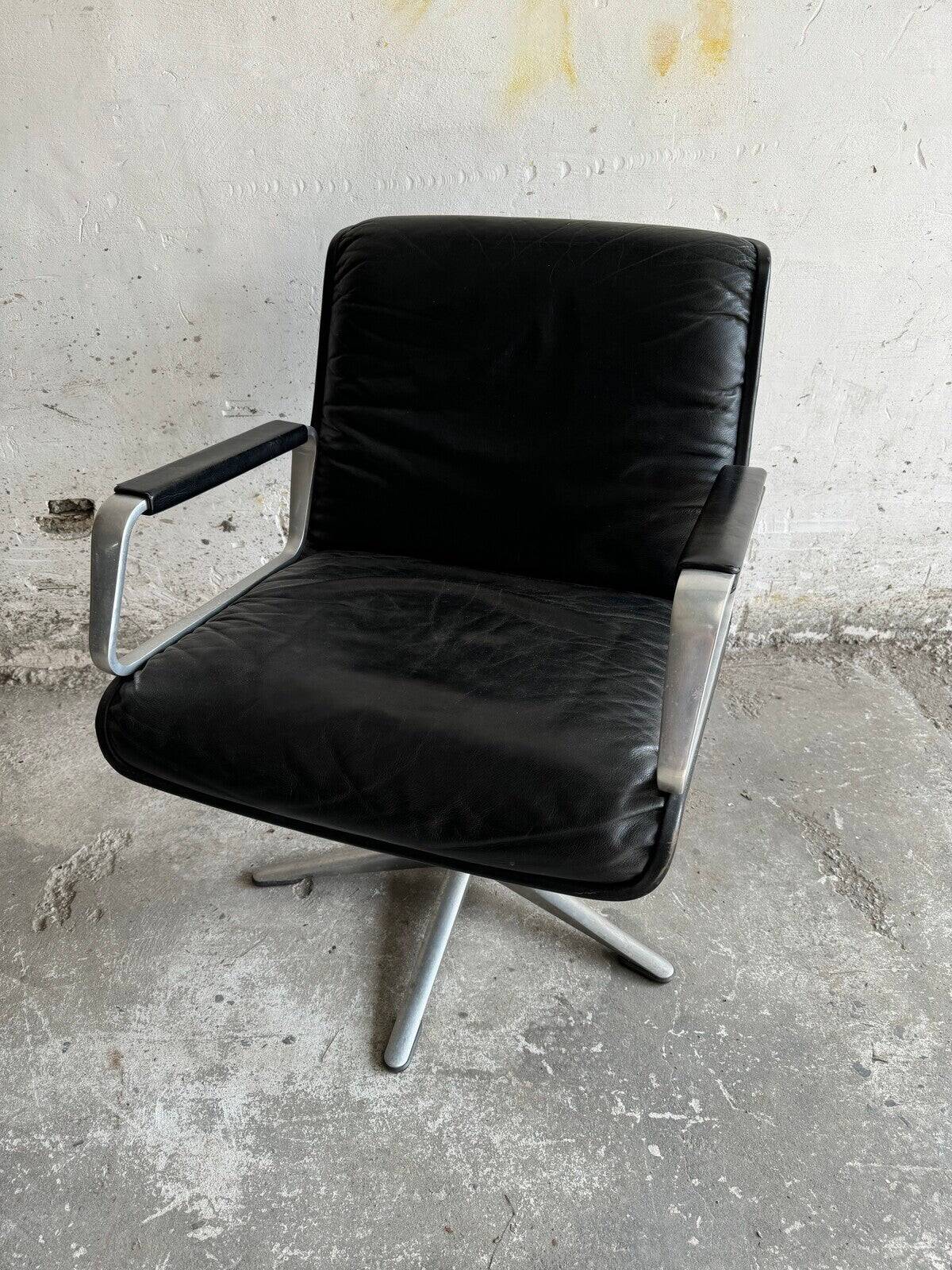 Wilkhahn Delta lounge chair in black leather with polished aluminum base and footrest (1970s)