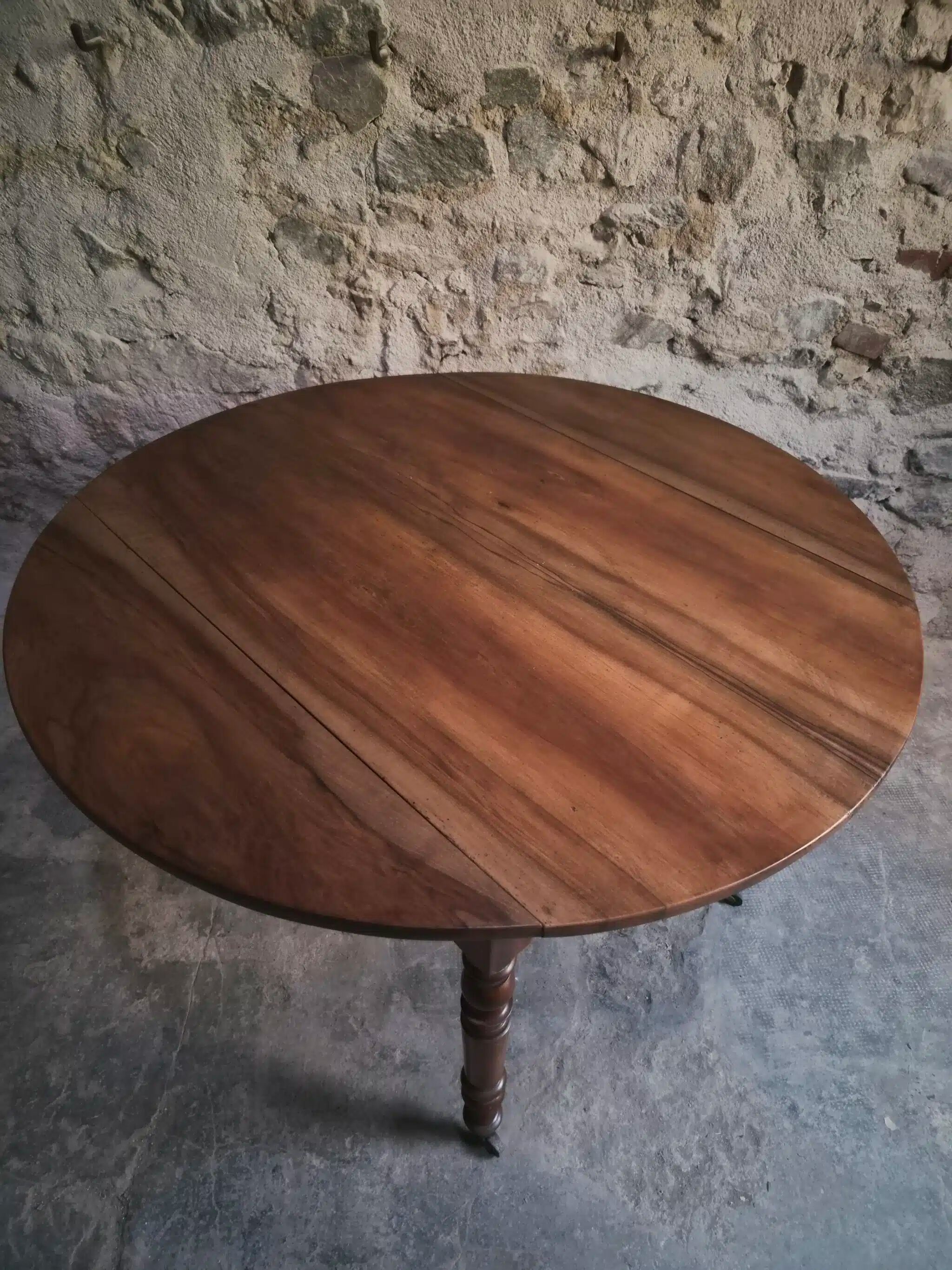 Antique drop-leaf dining table in walnut, France, circa 1900.