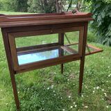 Glass-enclosed old tea table with wooden tray, bronze and brass