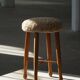 Danish sculptural stool from the mid-century modern period with a lambswool seat, 1960s.