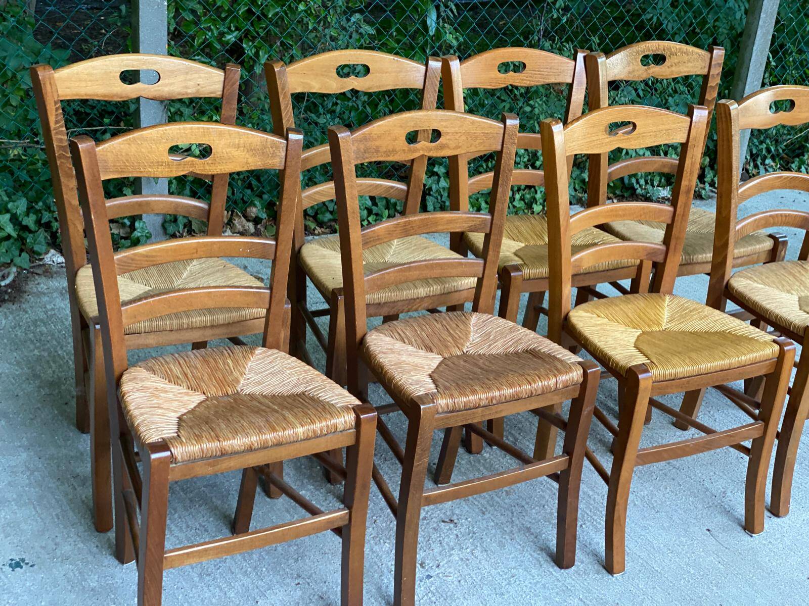 12 solid wood and straw chairs