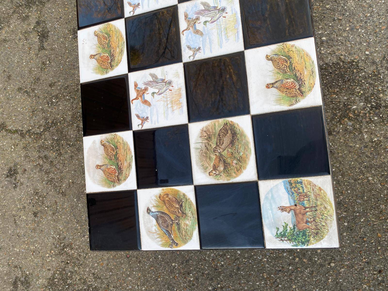 Vintage coffee table with black wrought iron and white tiles.