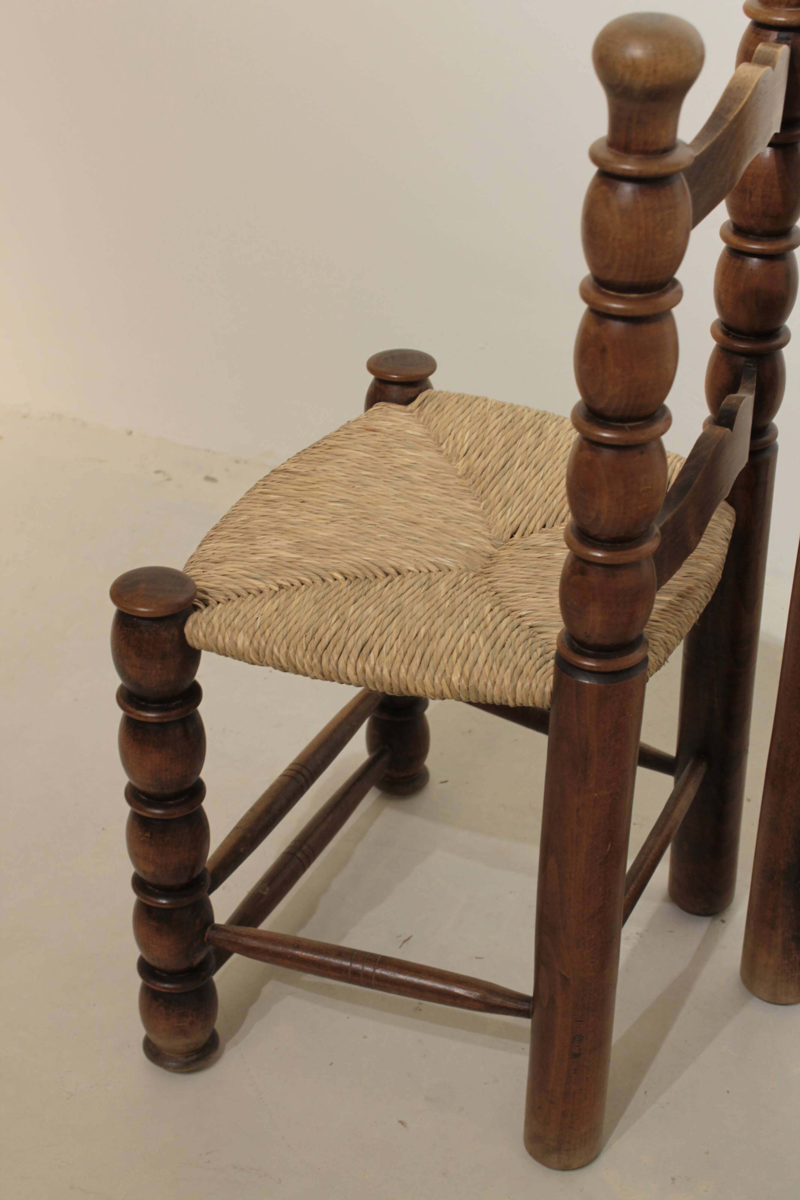 Pair of rustic chairs in turned wood with straw seats