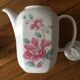 Vintage porcelain coffee or teapot with milk jug