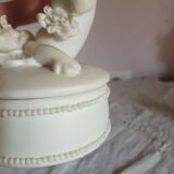 Small round box topped with a vintage biscuit porcelain angel