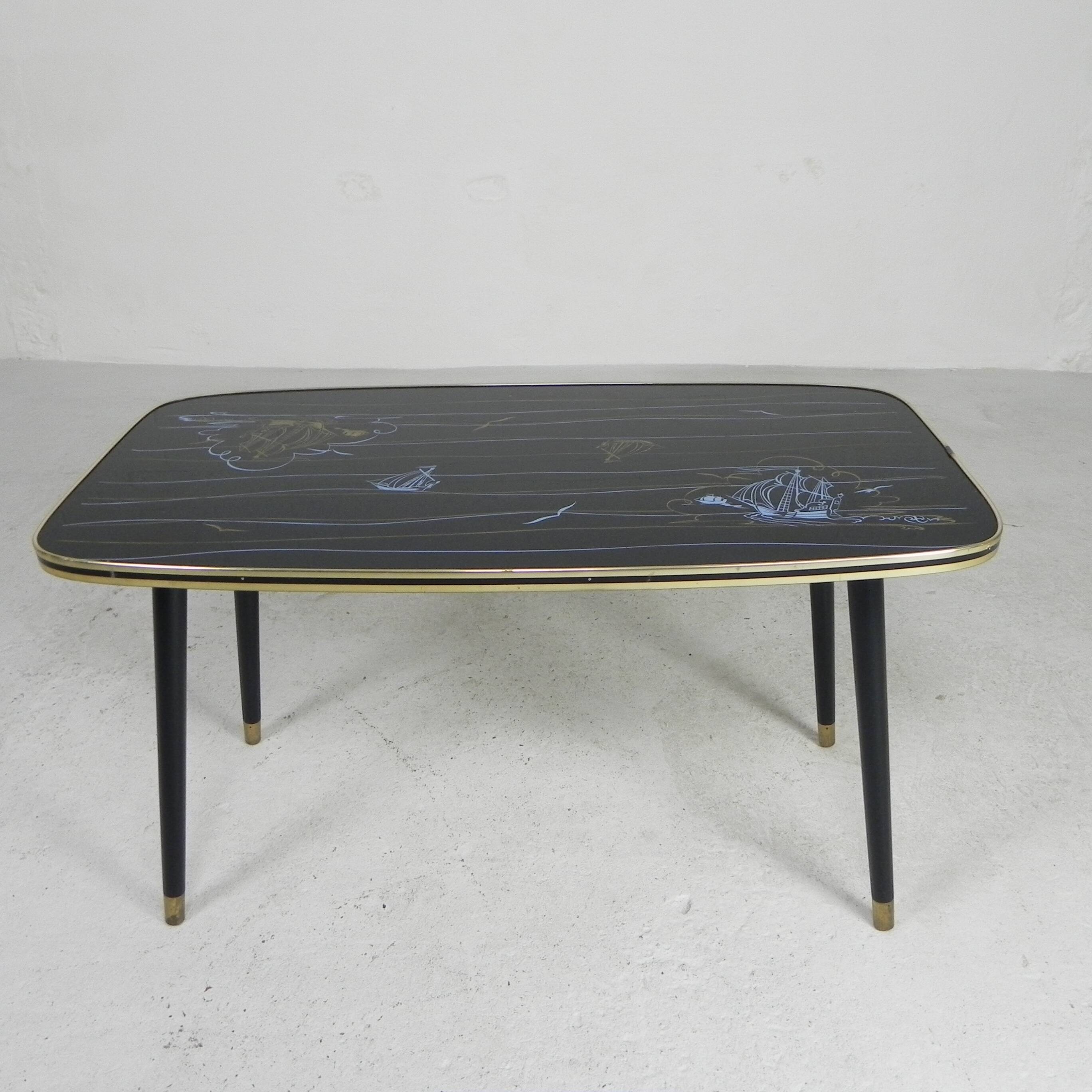 Vintage coffee table with glass top and angled legs