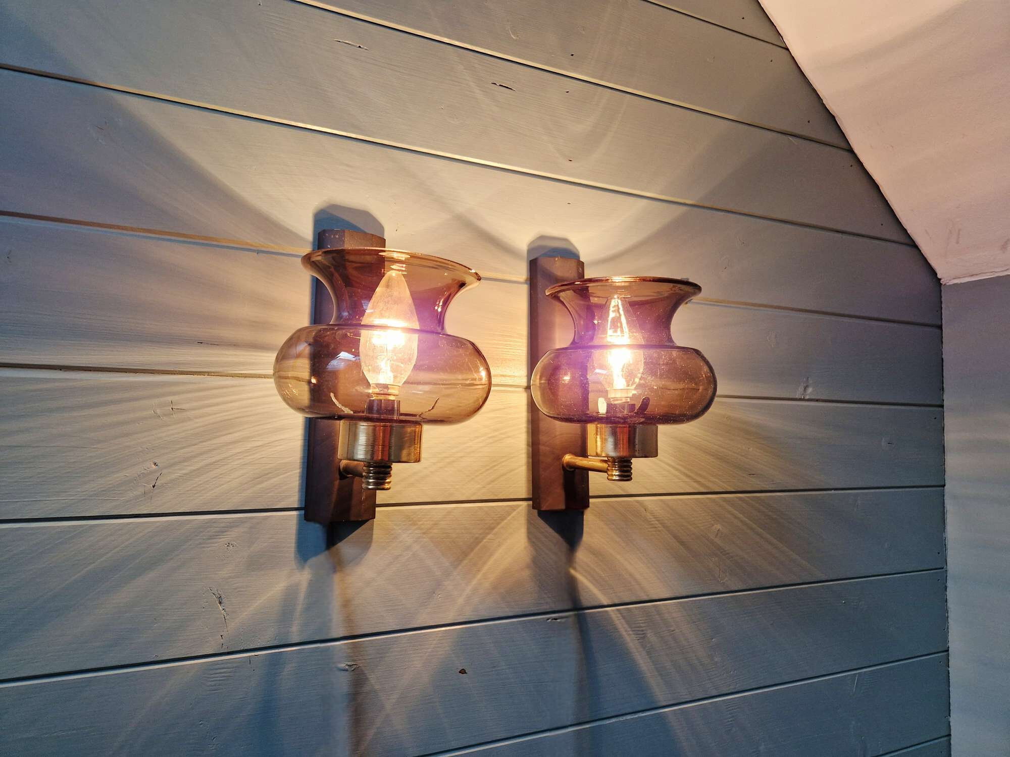 Pair of wall sconces in brass and smoked glass, 1960s.
