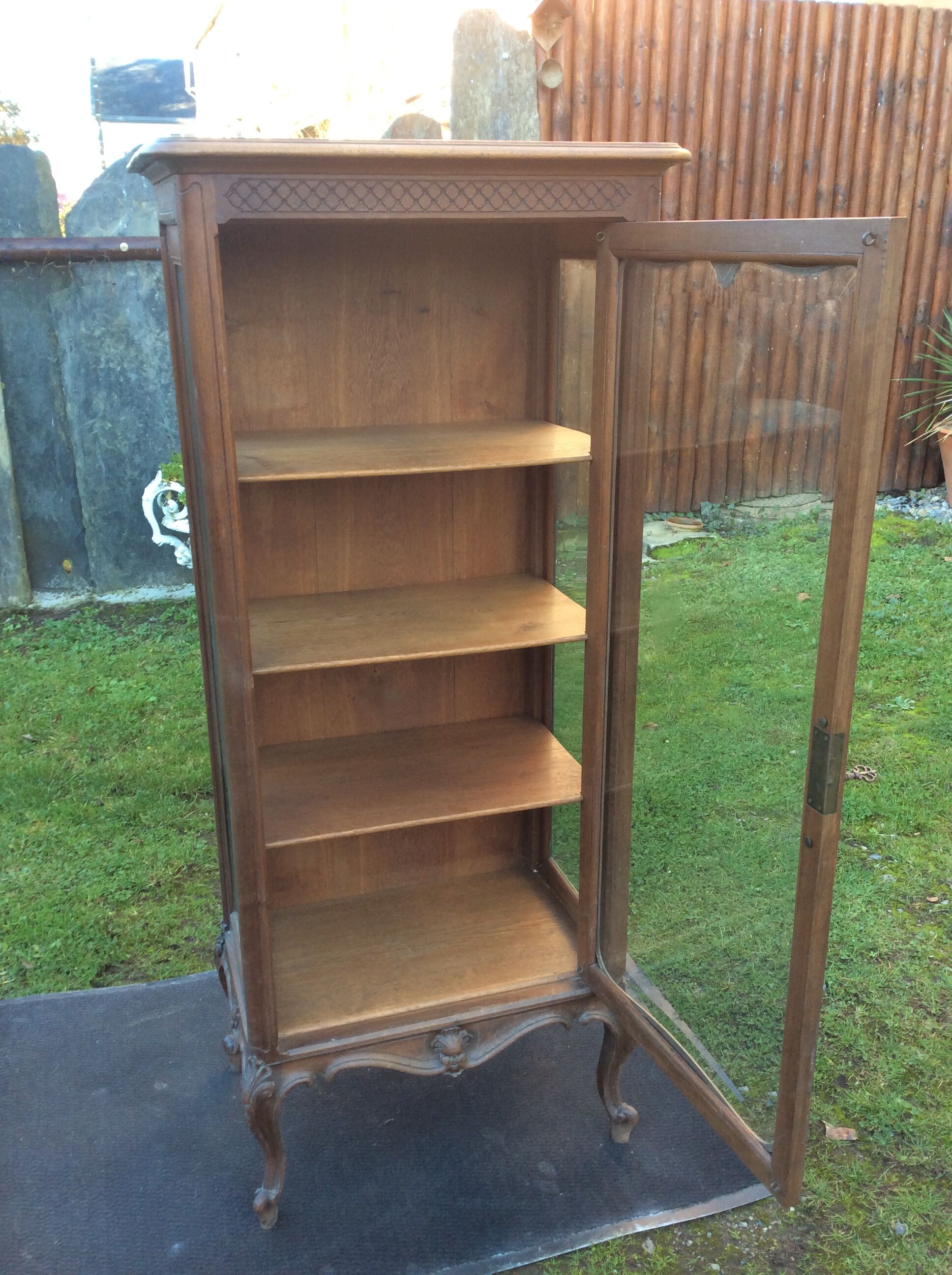 Louis XV Rocaille style showcase in solid walnut, beveled door glass.