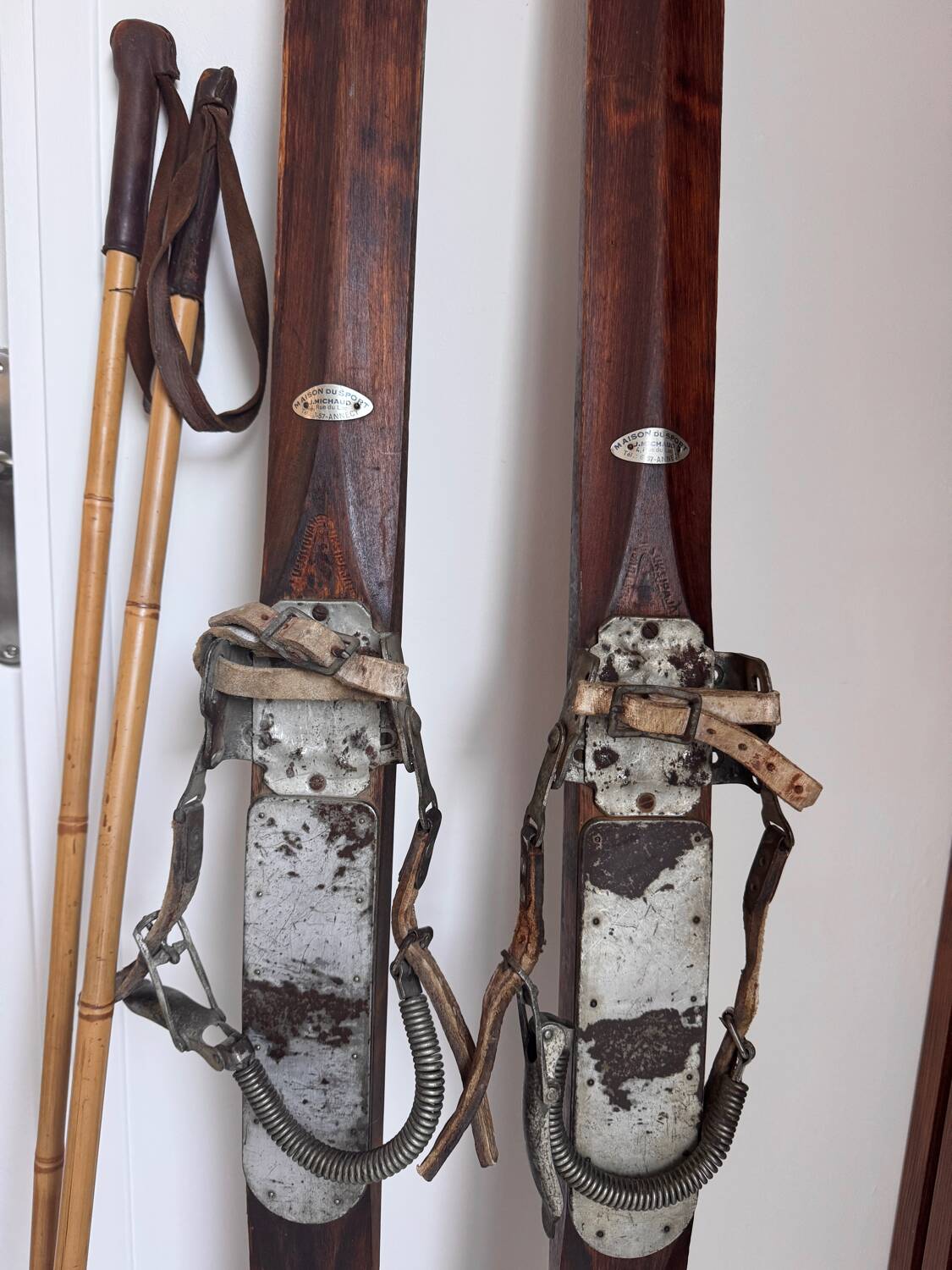 Antique wooden skis with vintage poles
