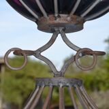 Large blown glass and wrought iron vase on shower stand