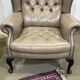 Pair of high-backed Chesterfield armchairs with 1 leather footrest