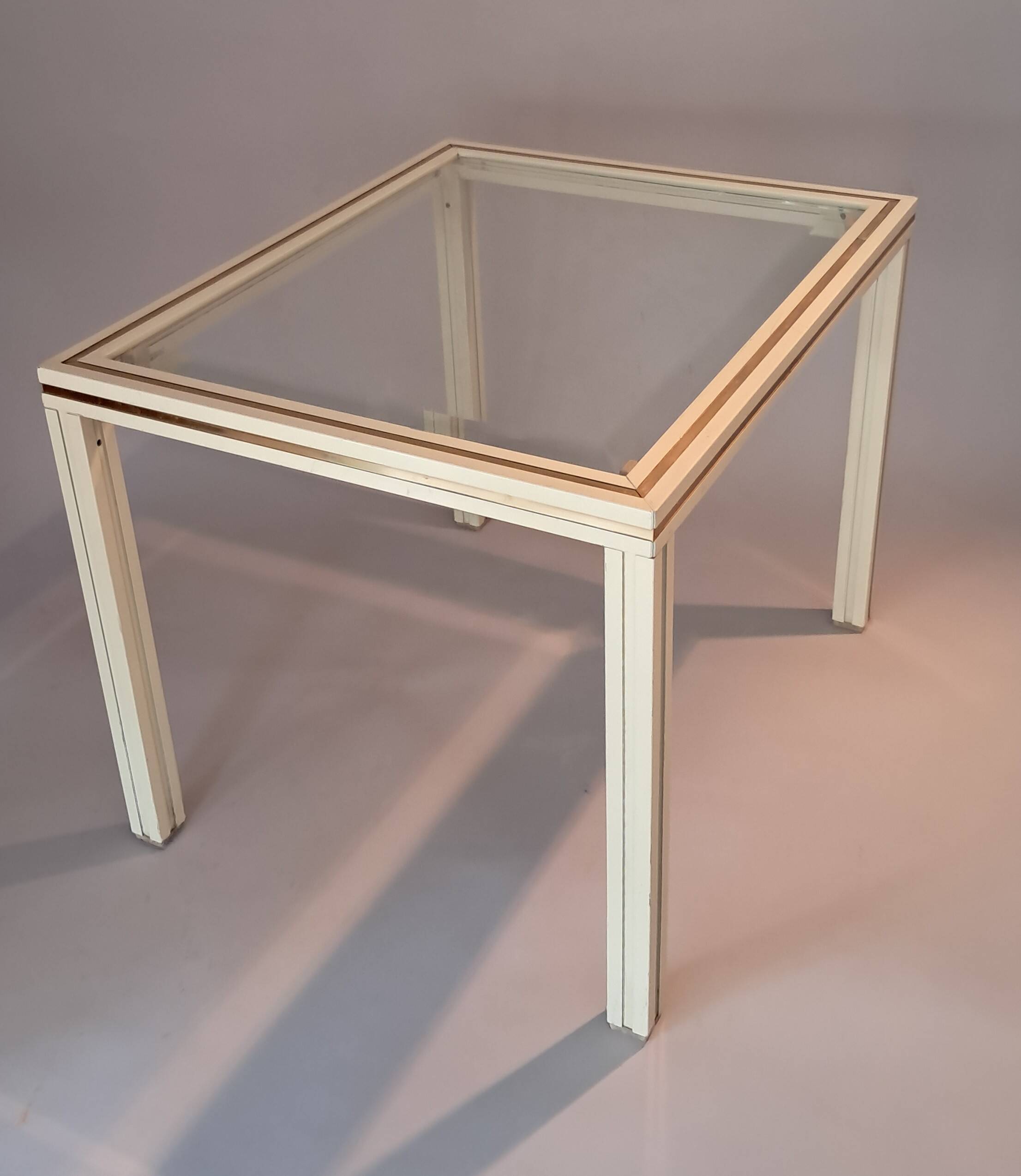 White lacquered side table by Pierre Vandel with gold brass.
