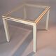 White lacquered side table by Pierre Vandel with gold brass.
