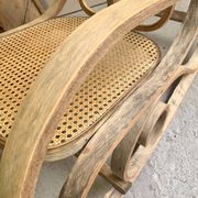Rocking chair with a cane seat and backrest.
