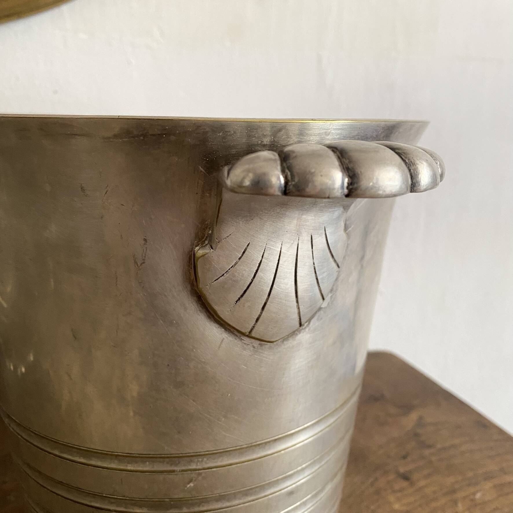 Antique champagne bucket with shell handles.