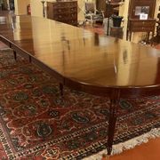 Extensible dining table from the Louis XVI period in mahogany with a banded top.