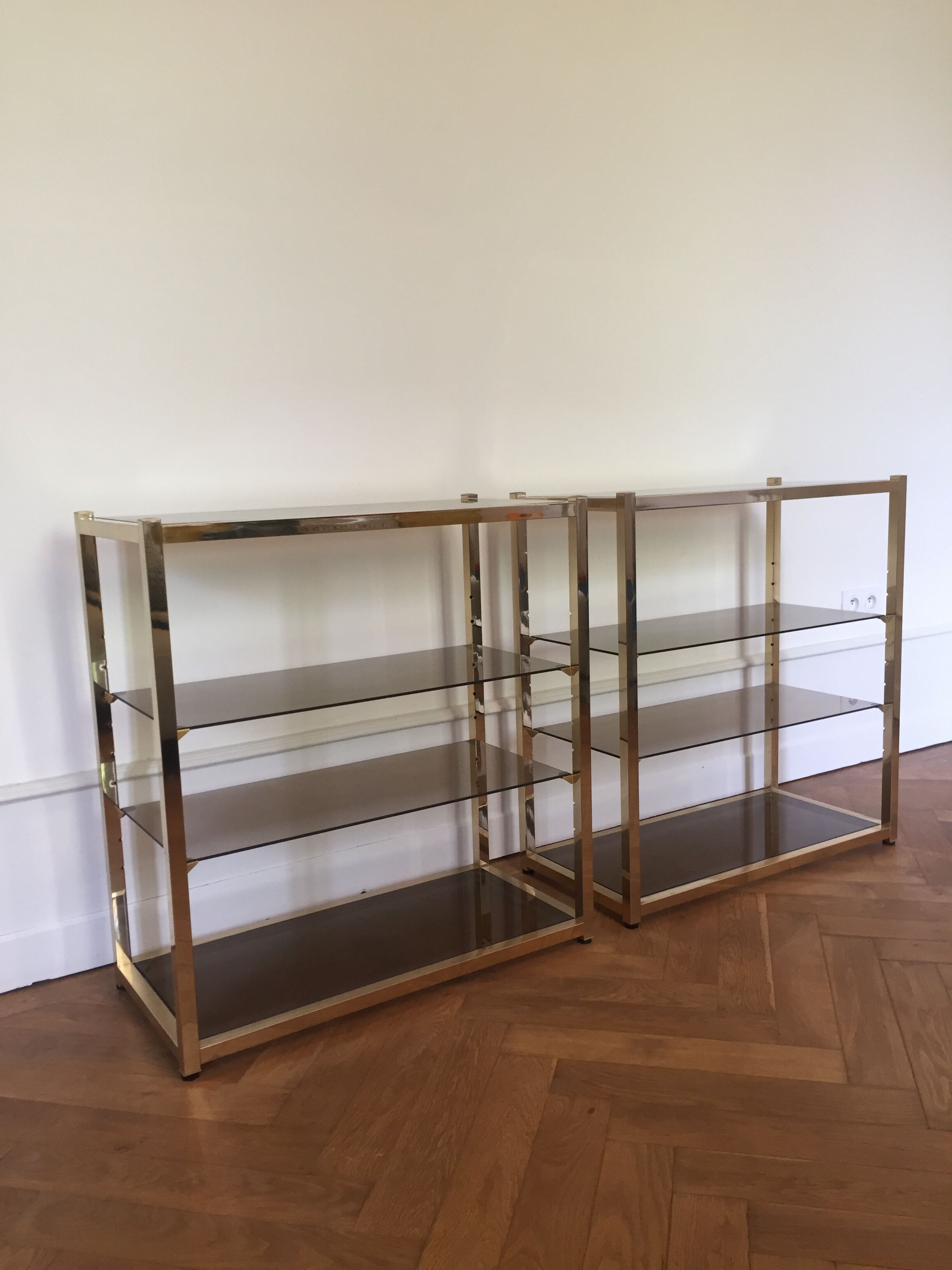 Pair of consoles brass shelves and smoked glass design Roche Bobois