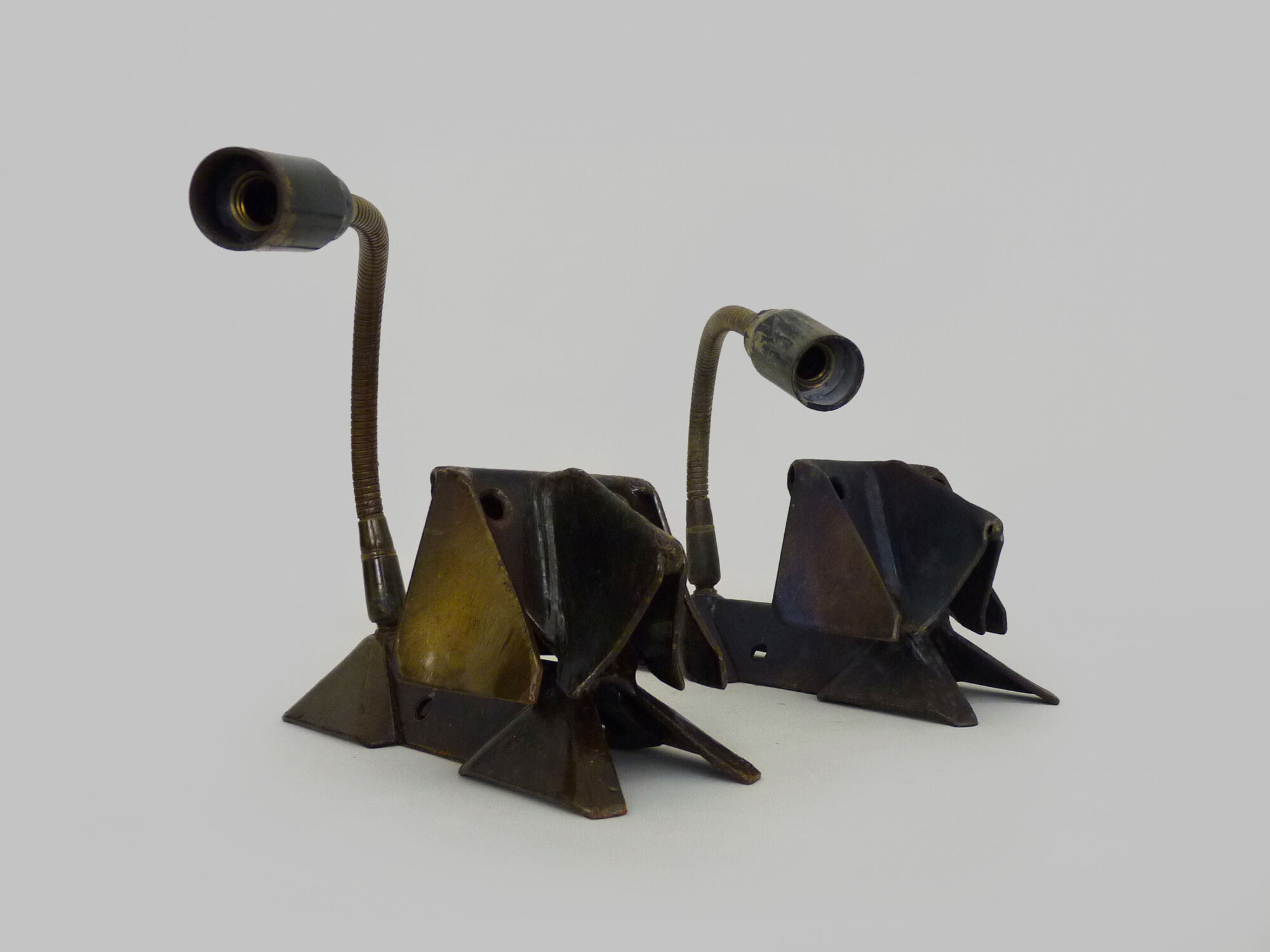 Pair of cast iron wall sconces with articulated arm, dog shape. Vintage