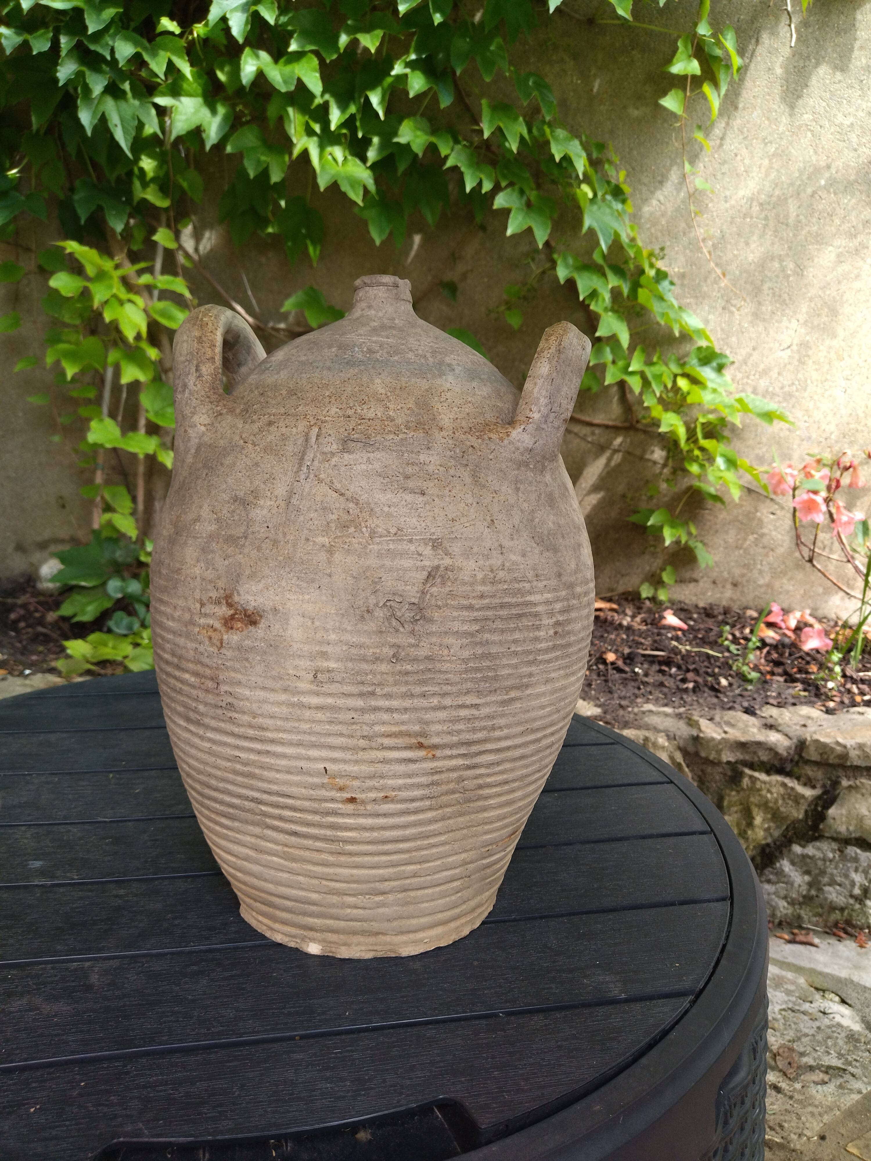 Ancient sandstone jar with two handles