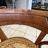 Bistro chair with a curved wooden frame and caned seat from the 1930s.