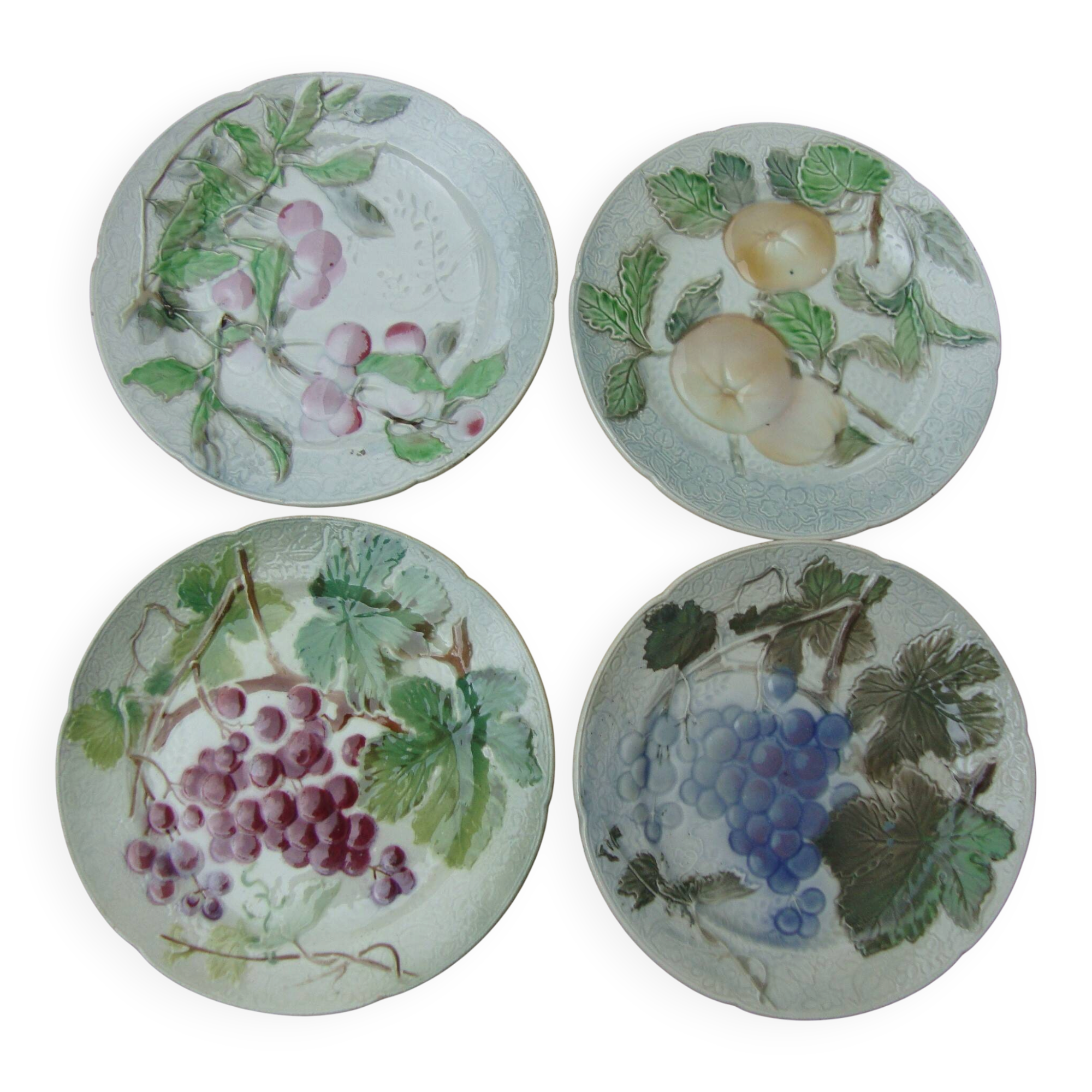 Set of 4 Keller and Guerin St Clement Majolica plates with fruit decoration.