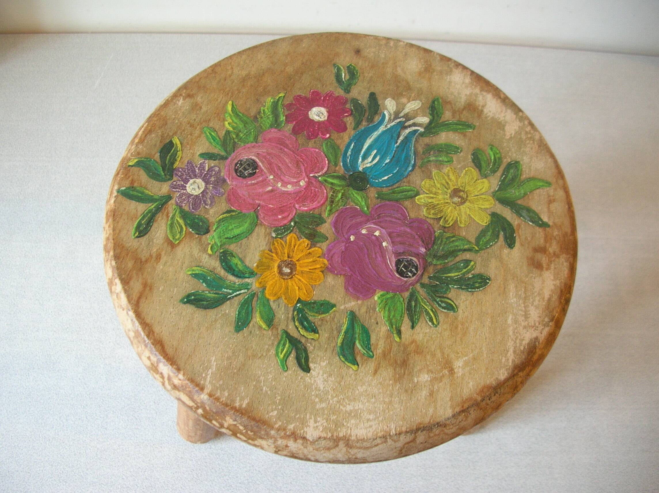 Old tripod stool with 3 wooden legs, painted floral decoration, flower bouquet