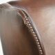 Cowhide wingback armchair in English style finished with decorative nails