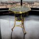 Gueridon tripod with gilded bronze frame covered with portor marble