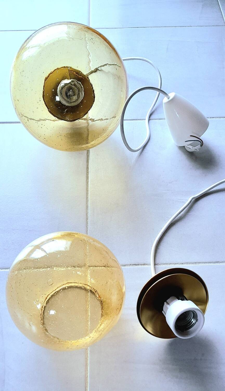 Set of 2 bubbled amber glass globe pendants