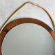 Vintage round wooden wall mirror with hooks
