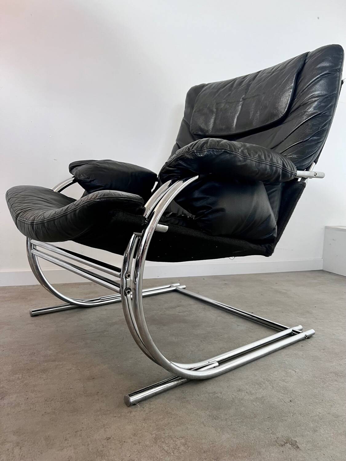 Old armchair and ottoman black leather tubular chrome bauhaus design from the 70s