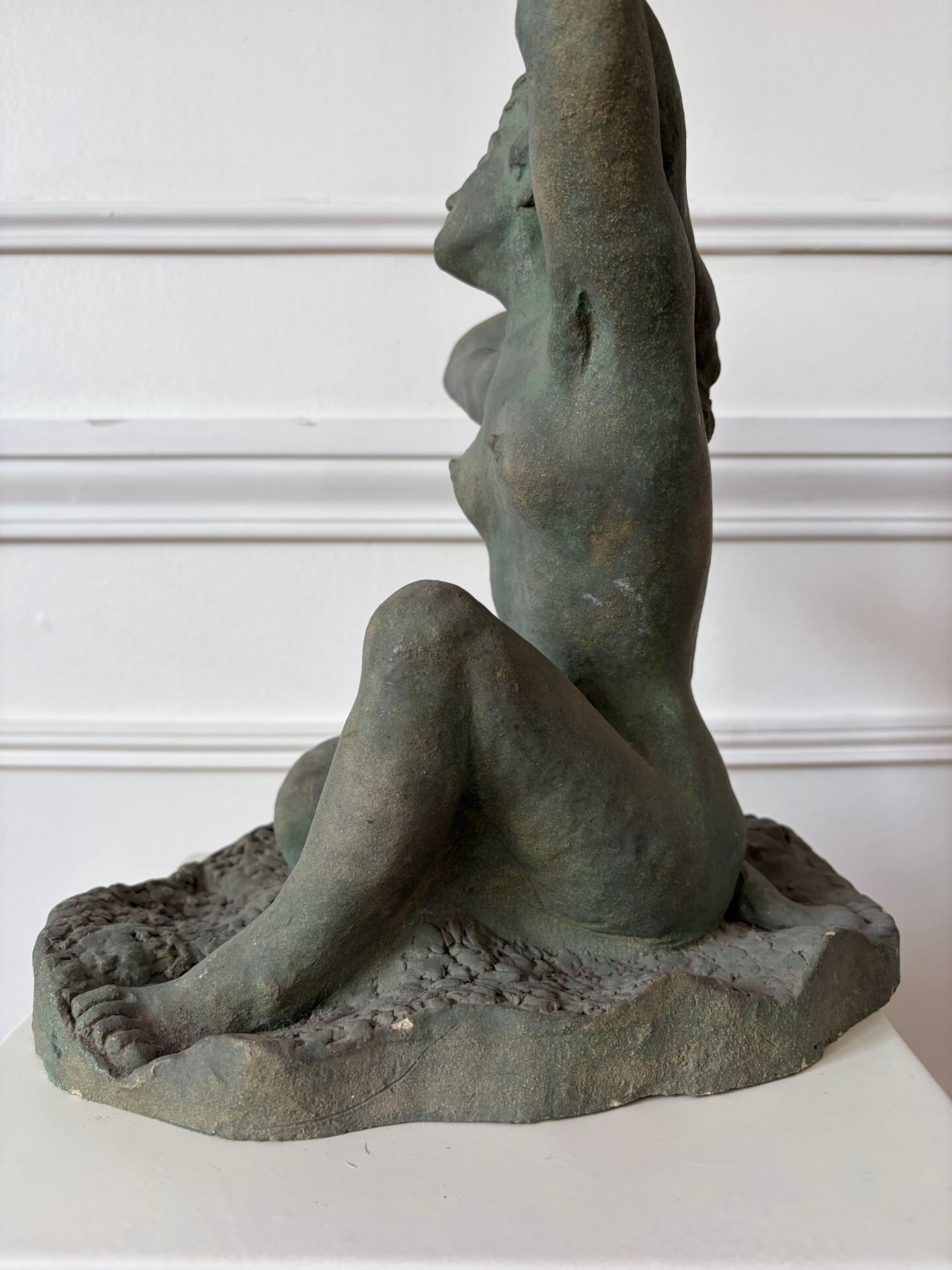 Sculpture of a naked woman titled "Youth" in terracotta.