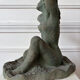 Sculpture of a naked woman titled "Youth" in terracotta.