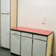 Table, chairs and kitchen furniture in red and black formica