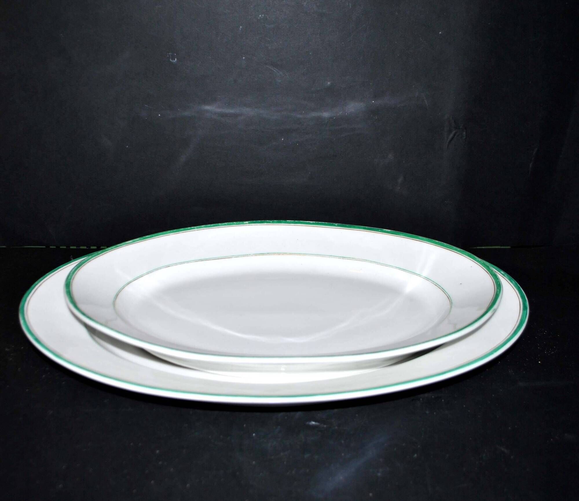 Limoges set of 2 old oval porcelain dishes with green and gold edging