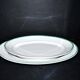 Limoges set of 2 old oval porcelain dishes with green and gold edging