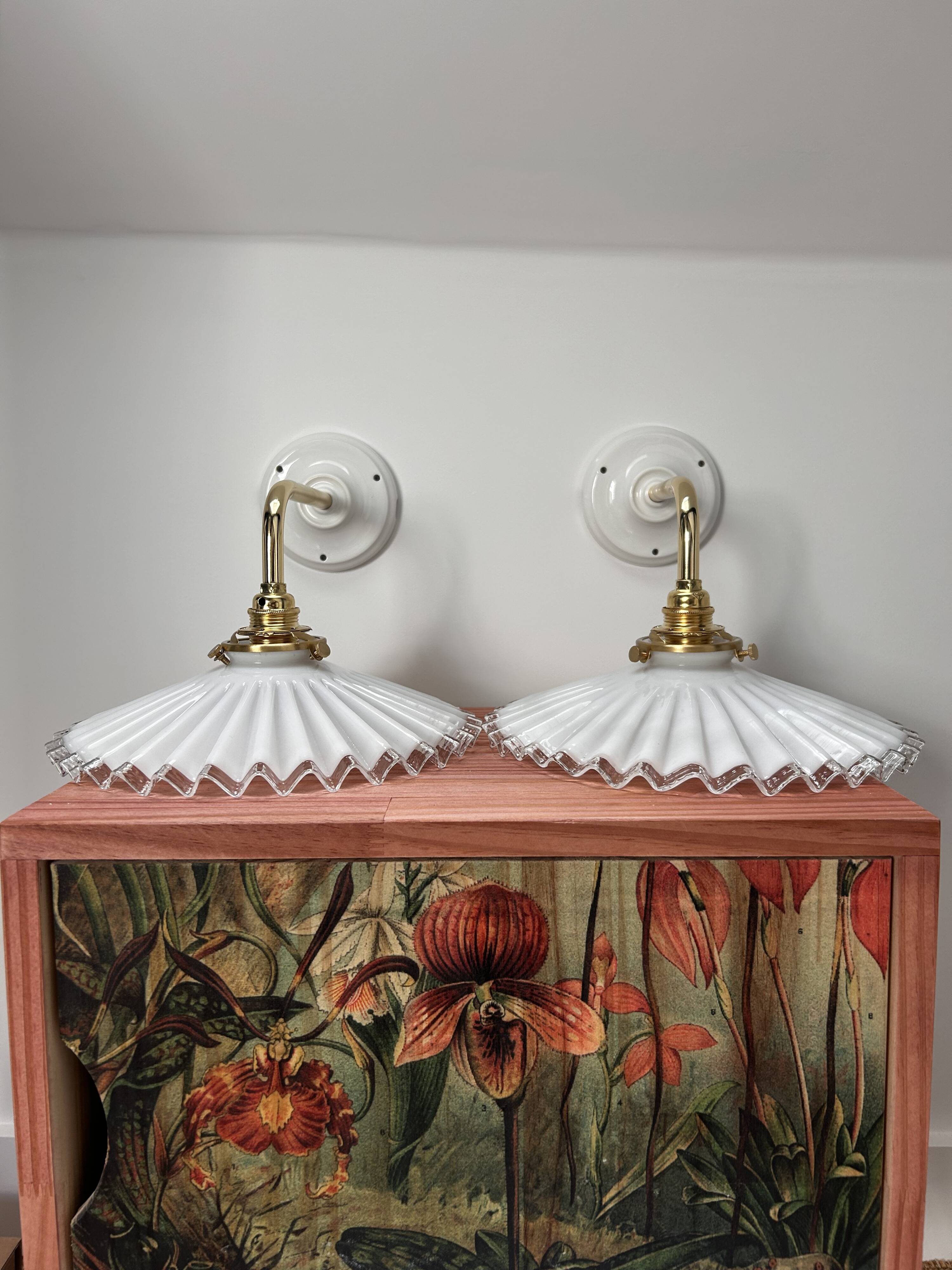Two wall sconces in serrated white opaline